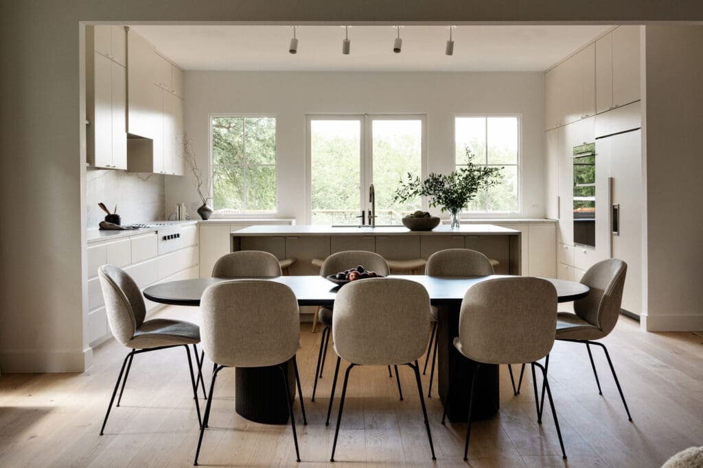 Timeless kitchen and dining room by House Franc with natural light, white oak, and quartzite countertops