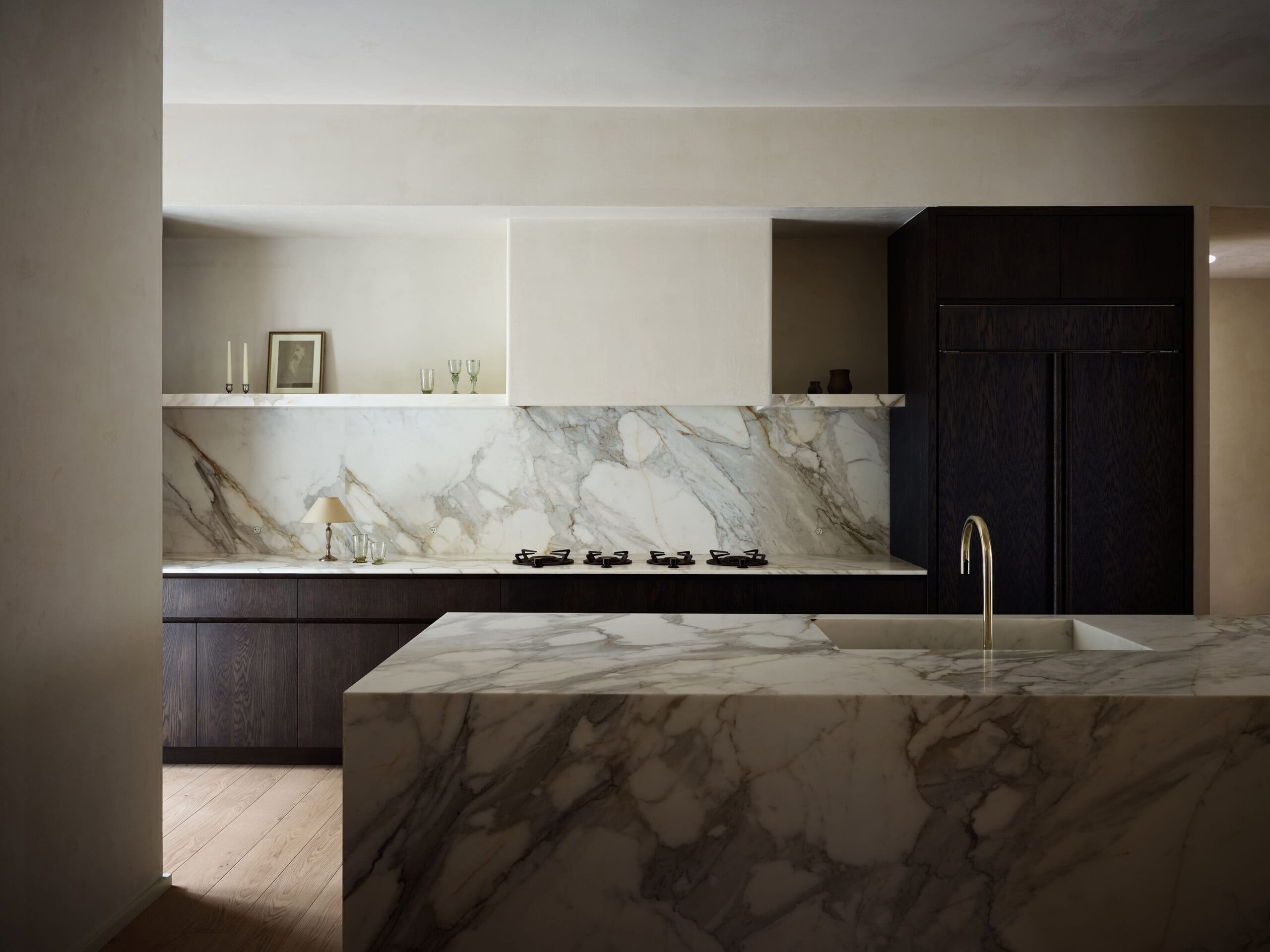 marble and plaster kitchen, dark oak cabinetry